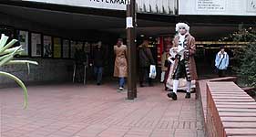 guy in fancy dress, aware that he looks silly