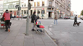 Mother with push chair, homeless pushing trolley with belongings