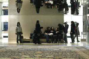 V&A Ardebil carpet on display, group of students behind it