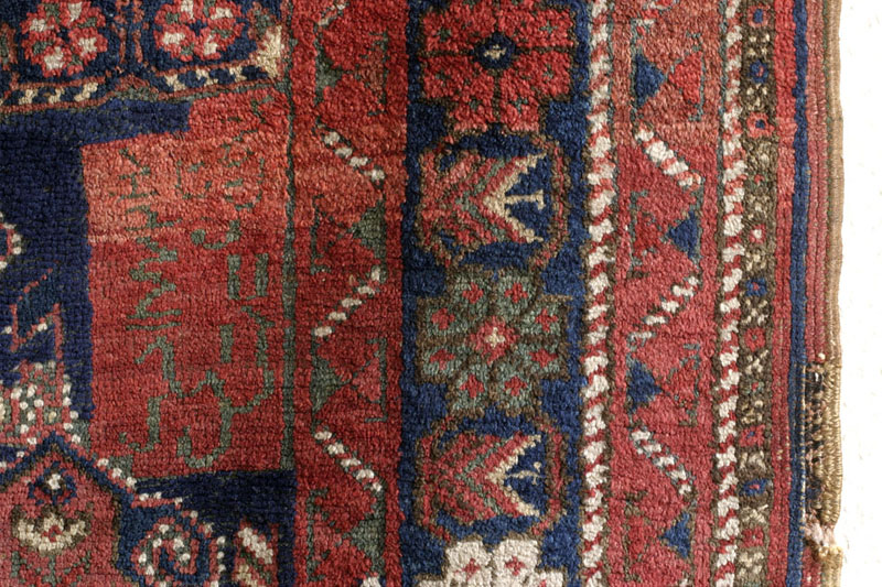 Dated Afshar rug with camel cartouche, Kerman area, south Persia around 1900: cartouche with inscription showing two conflicting dates