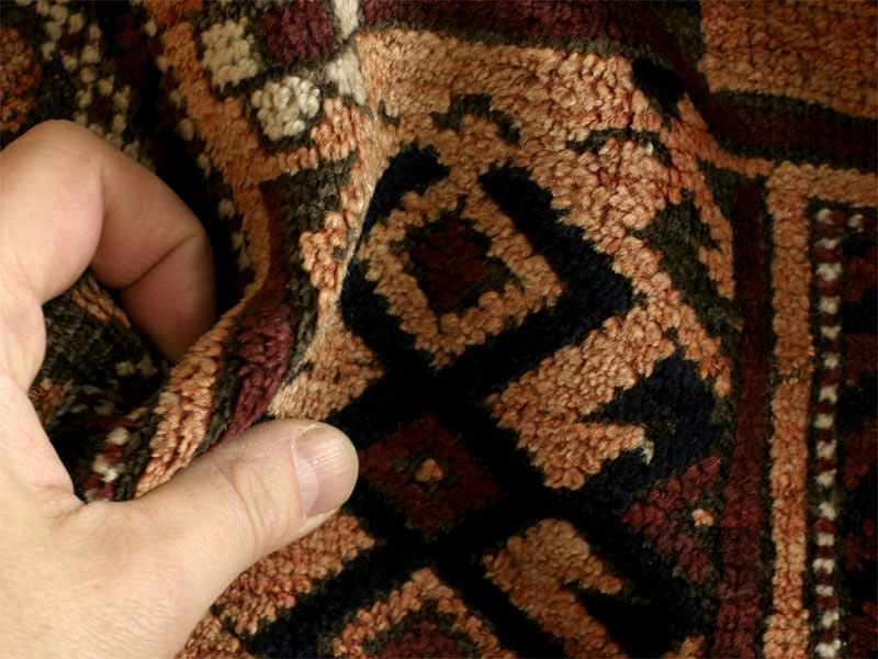 Baluch rug, wide meandering tree border with blossoms, pile fold