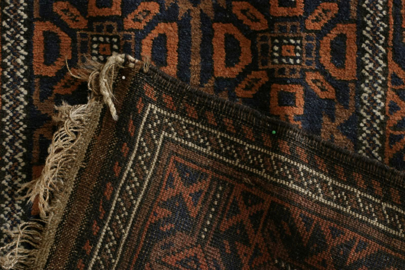 Small antique Khorassan Baluch rug with endless repeat diamond and flower design, back