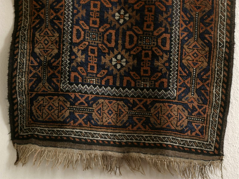 Small antique Khorassan Baluch rug with endless repeat diamond and flower design, bottom half