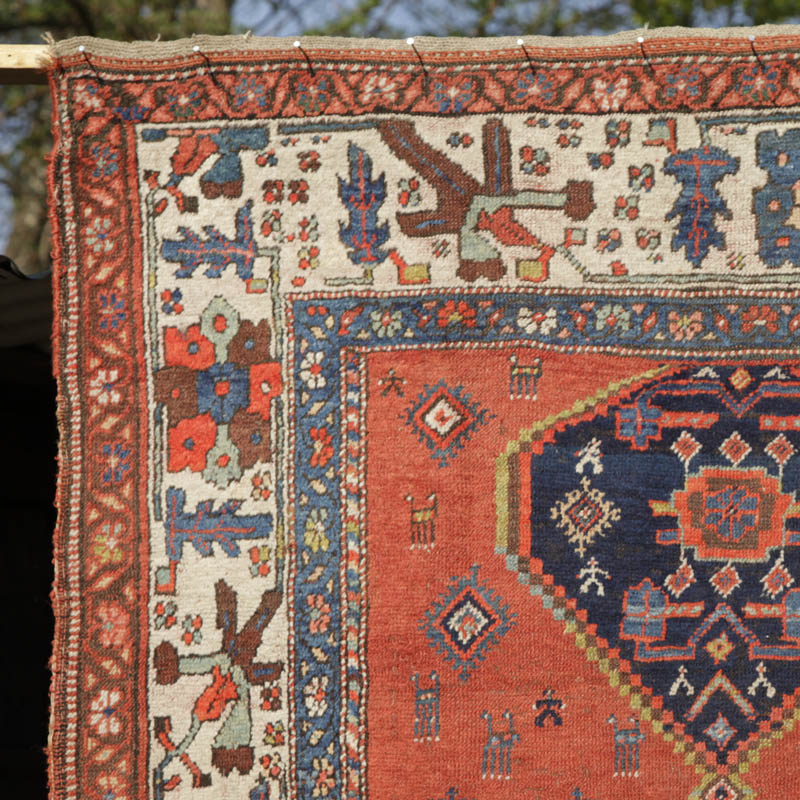 Kurdish medallion rug with humans and animals - top left corner