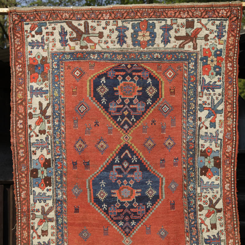 Kurdish medallion rug with humans and animals - top half