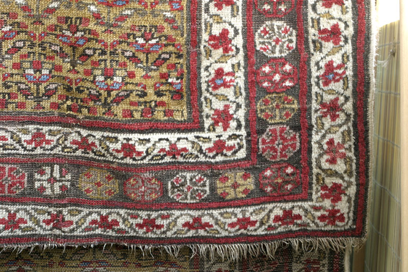 Antique Kurdish rug, end of 19th c., shrubs on yellow ground: bottom right area