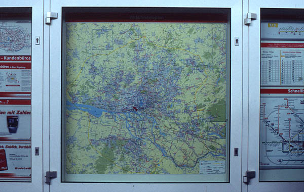 HVV info box at U-Bahn station Feldstrasse. Note that usability of the map is made difficult because you are already inside. Also the area is too large (the scale too small) to offer useful local navigation help. The local map sections introduced since this photo was taken have improved the situation).